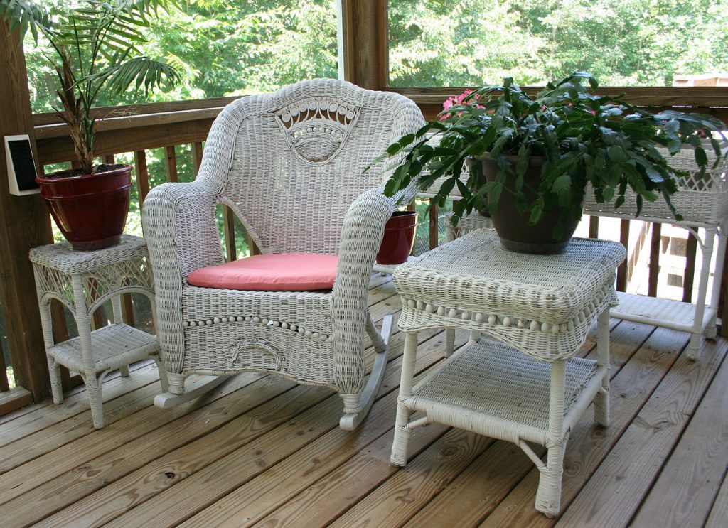 White wicker patio furniture on a balcony 