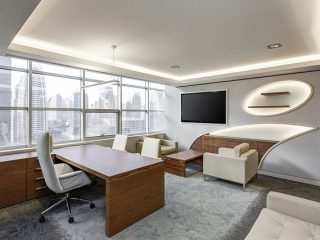 A modern office with light wood and white-colored furniture