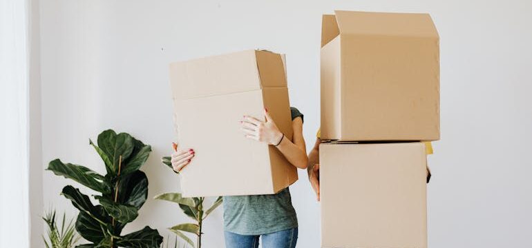 A couple is holding boxes and wondering