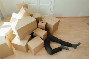 A person under a pile of cardboard boxes