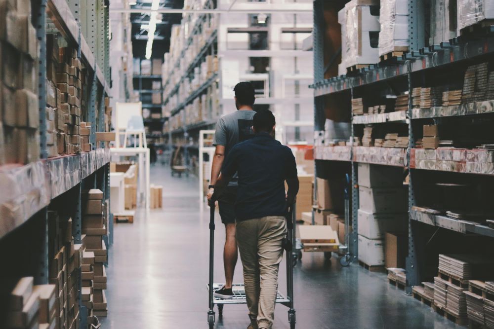 Two men are going into a storage room