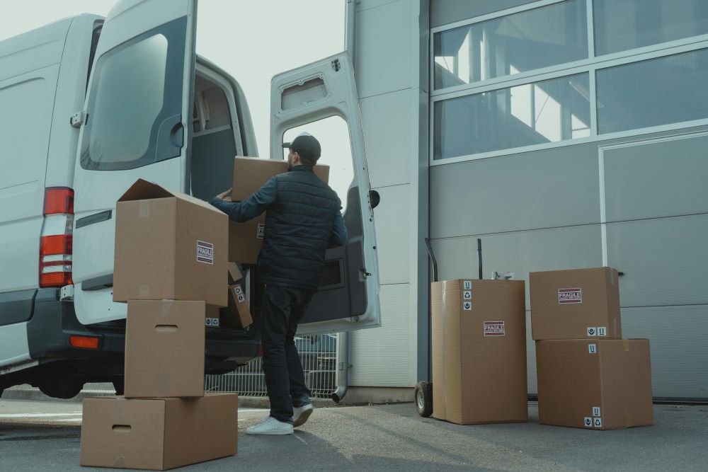 Movers putting boxes in a van