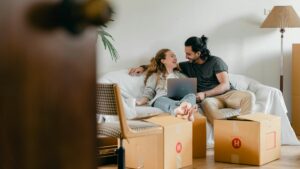 A woman and a man getting ready to move into their new home
