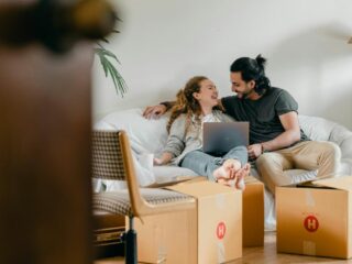 A woman and a man getting ready to move into their new home