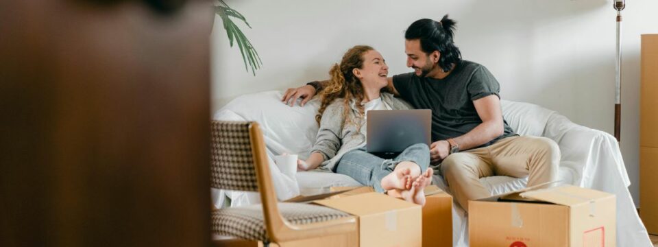 A woman and a man getting ready to move into their new home