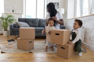 A mother with her two children packing boxes