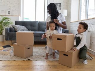 A mother with her two children packing boxes