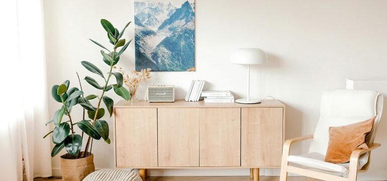 A cozy modern living room with a gray lounge chair and soft pillows showing how to repurpose old furniture for modern spaces.