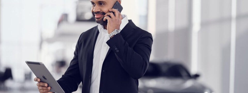 A car service center executive talking on a cellphone