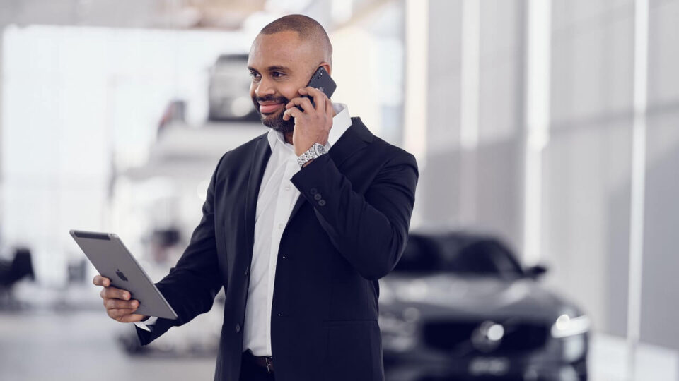 A car service center executive talking on a cellphone
