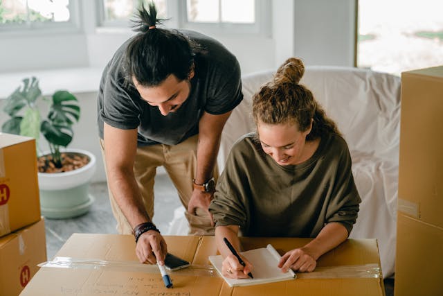 couple writing in notebook before relocation