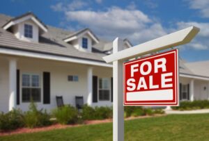 a beautiful home with 'for sale' sign