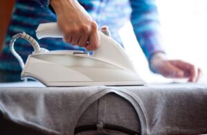 a man ironing clothes